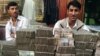 Afghanistan - Two Afghan money changers wait for customers at a money exchange market in Kabul, 18Jun2007