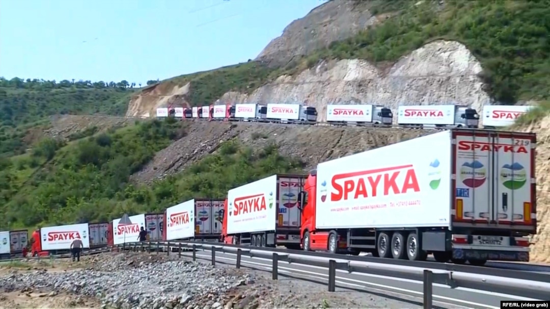 An Armenian convoy of trucks waits near an Azerbaijani checkpoint at the beginning of the Lachin Corridor on July 27. 