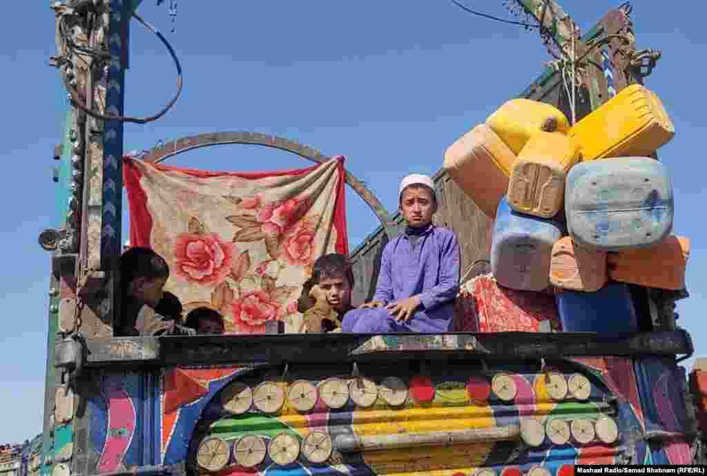 Young boys sit atop a truck that will carry them across the border at Chaman. Since ousting the Western-backed Afghan government and taking over the country in August 2021, the Taliban has placed restrictions on women's appearance, freedom of movement, right to work and study, and access to society. Restrictions have also been placed on the media, activists, and civil society organizations.