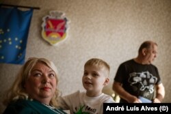 Oksana Kovaleva, her son Oleksandr, and Oleksiy Pasyuga in Velyka Pysarivka