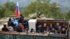 Ethnic Armenian flee Karabakh for Armenia sitting in a truck at the Lachin checkpoint controlled by Russian peackeepers and Azeri border guards, 26 September 2023.