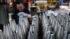 An employee handles 155 mm caliber shells after the manufacturing process at the Scranton Army Ammunition Plant (SCAAP) in Scranton, Pennsylvania on April 16, 2024