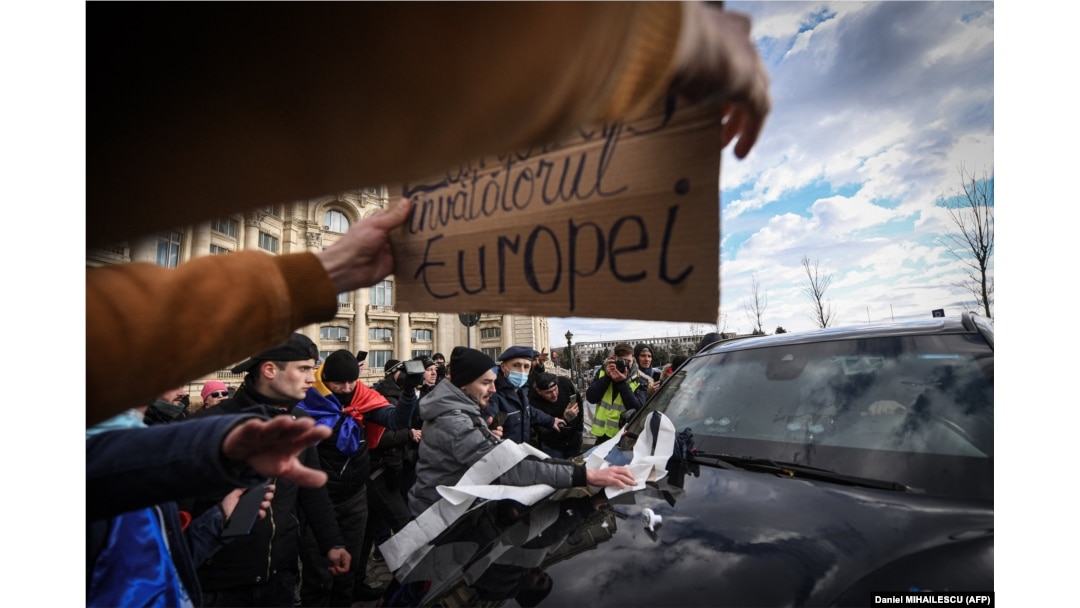 Protesters throw toilet paper and spit on the windshield of a car belonging to a diplomatic mission as they storm the parliament on December 21.