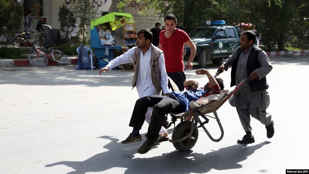 A wounded man is carried away from the site of a deadly twin bomb attack in Kabul, which killed at least 25 people on April 30. 