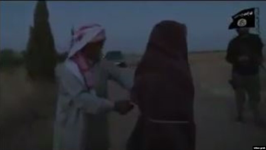 The video, whose authenticity cannot be verified, shows a young woman clad in black, with several IS militants and a man who appears to be her father. 