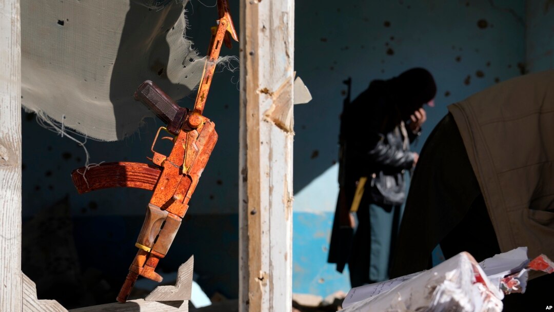 A gun hangs in a house belonging to Islamic State fighters that was destroyed in the ongoing conflict with the Taliban in Kabul on January 5.