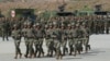 Chinese military personnel run in front of Cambodian soldiers as part of a joint military exercise in 2024.