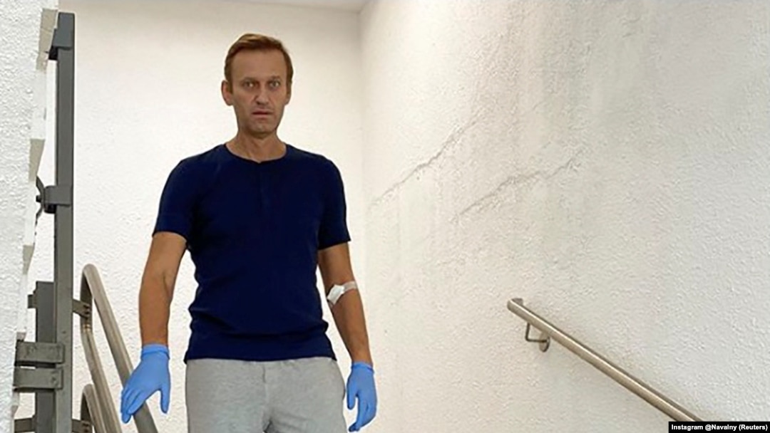 Russian opposition politician Alexei Navalny walks down stairs at Charite hospital in Berlin in an undated image obtained from social media.