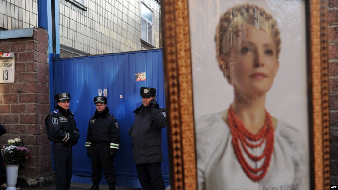A supporter of Yulia Tymoshenko holds her portrait during rally in front of a prison in Kyiv last year.