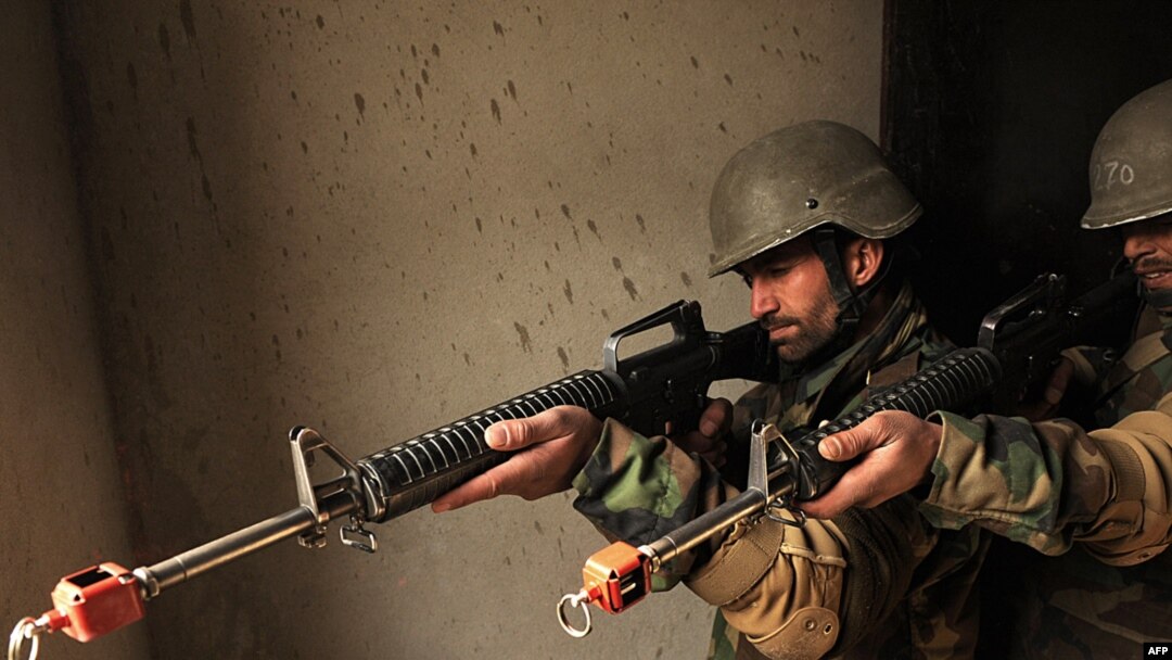 Afghan soldiers, armed with U.S.-made M16 rifles, take part in combat training at a training camp on the outskirts of Kabul on December 28.