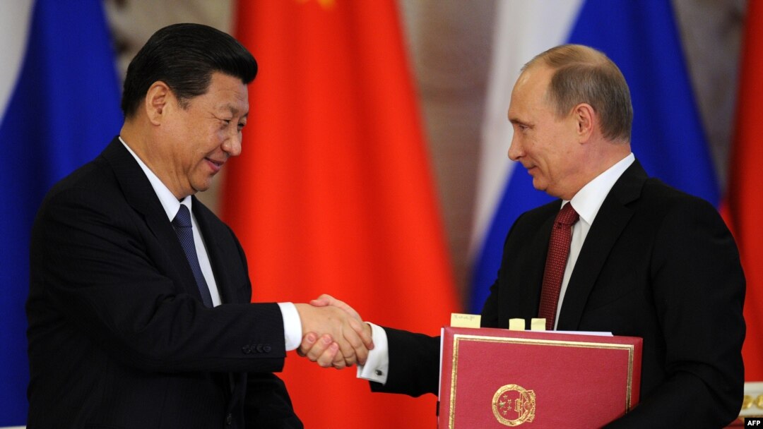 Russian President Vladimir Putin (right) shakes hands with his Chinese counterpart, Xi Jinping, during a document-signing ceremony in Moscow in March.