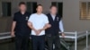 A photo provided by Georgia's State Security Service appears to show officers escorting Giorgi Bachiashvili in handcuffs. 