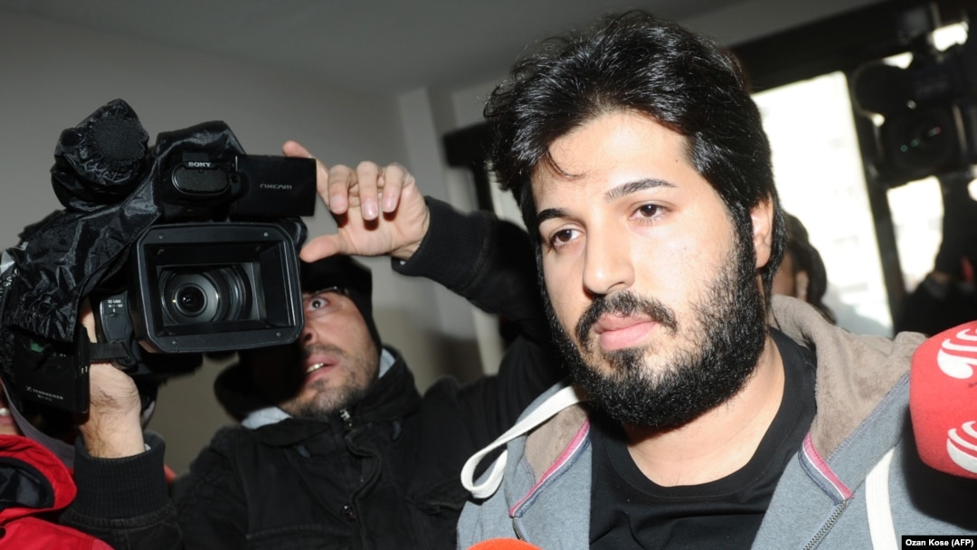 Reza Zarrab, a dual citizen of Turkey and his native Iran, is surrounded by journalists as he arrives at a police center in Istanbul in December 2013. Will his U.S. trial expose facts Turkey's president would rather not be made public?