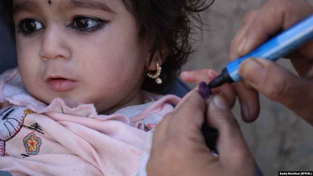 An Afghan girl receives a polio vaccine in the southern Afghan city of Kandahar.