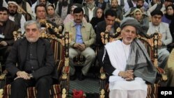 Afghanistan -- Afghan President Ashraf Ghani (R) and Chief Executive Abdullah Abdullah (L) meet the families of the victims of a suicide bomb attack in Jalalabad, April 23, 2015