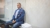 Як заявляє адвокат Олега Гладковського (на фото – в залі суду під час обрання запобіжного заходу), йому закидають неявку на допит, хоча він попередив НАБУ, що буде за кордоном