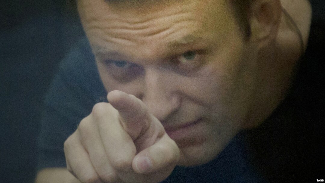 Russian opposition leader Aleksei Navalny gestures inside a glass-walled cage during his court hearing in Kirov on July 19