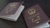 A handout video grab from footage published on the social media pages of Ukrainian President Volodymyr Zelenskyy shows alleged Chinese passports of two men captured by Ukraine's military. 
