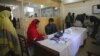 Pakistan -- A doctor writes a prescription for her patient at a hospital in Quetta, Balochistan, 14Dec2012