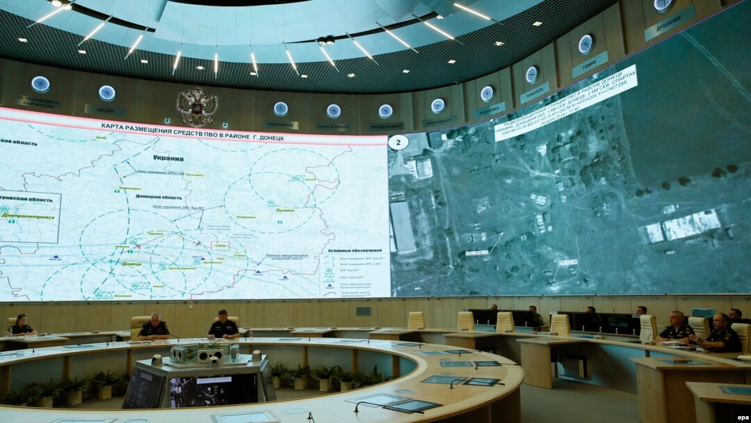 Russian defense officials sit in front of a map of air-defense locations in the area of Donetsk during a briefing by Russian Lieutenant General Andrei Kartopolov and Lieutenant General Igor Makushev in Moscow on July 21 to present Moscow's view of the MH17 downing.