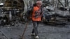 A Ukrainian municipal worker cleans an area at the site of a Russian drone strike on Dnipro on April 9.
