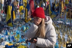Жінка плаче біля народного меморіалу пам'яті убитих Росією. Київ
