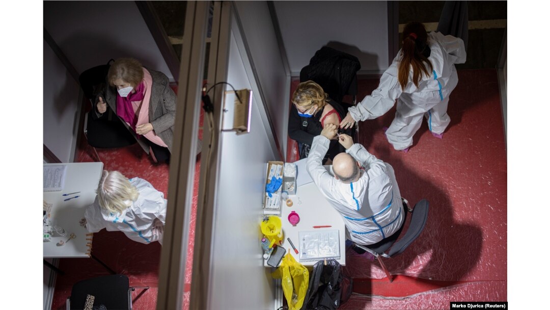 A woman receives a dose of the Sinopharm vaccine as Serbia begins mass vaccination against COVID-19 in Belgrade on February 2.
