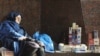 Ukraine -- An elderly woman sleeps as she sells cigarettes to make some money in the centre of Kyiv, 24Oct2008