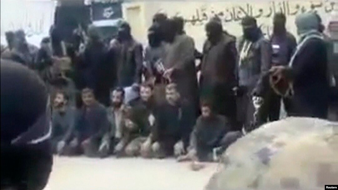 A video grab from an amateur video shows Syrian rebels sitting on the ground before their public execution by IS militants.