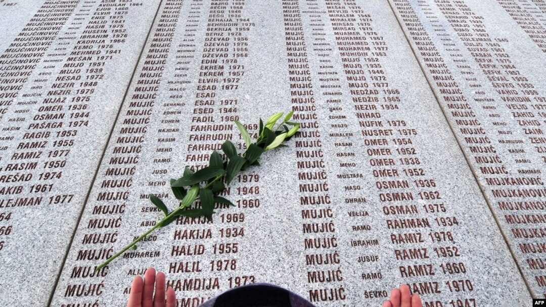 A Muslim woman prays at the Potocari memorial cemetery, near Srebrenica, in March 2010.