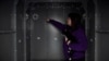 Kateryna Storozhuk shows the Life Capsule home shelter she installed in the spare room of her apartment in Bucha, Ukraine.